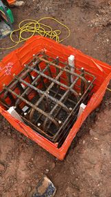 Pile cap reinforcement cage set inside a proprietary shutter in excavated ground